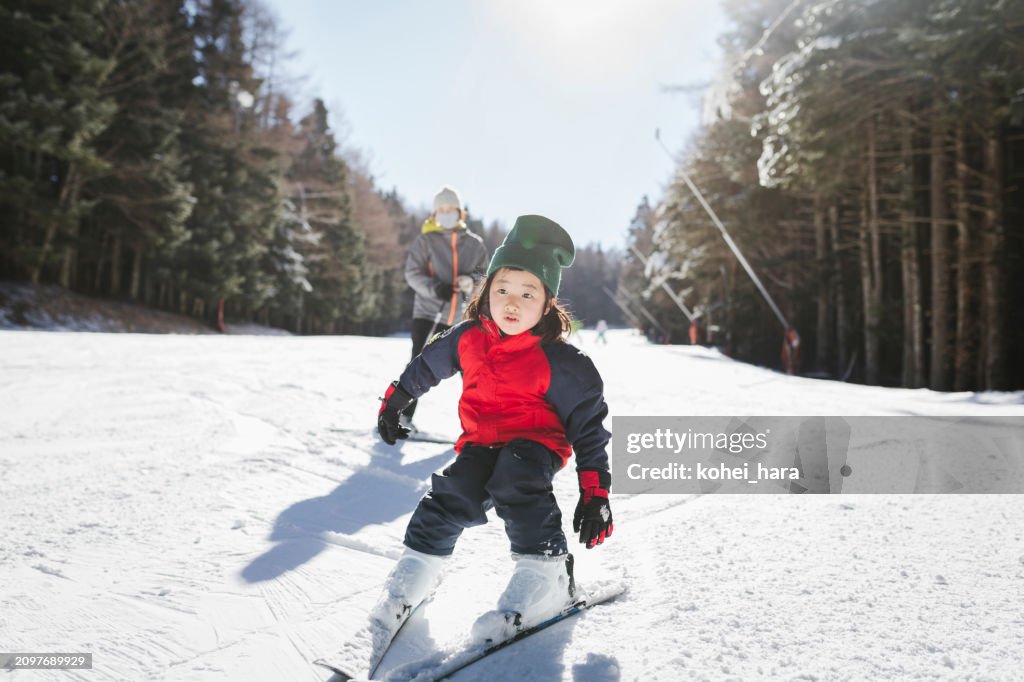 Mother and daughter enjoy skiing together