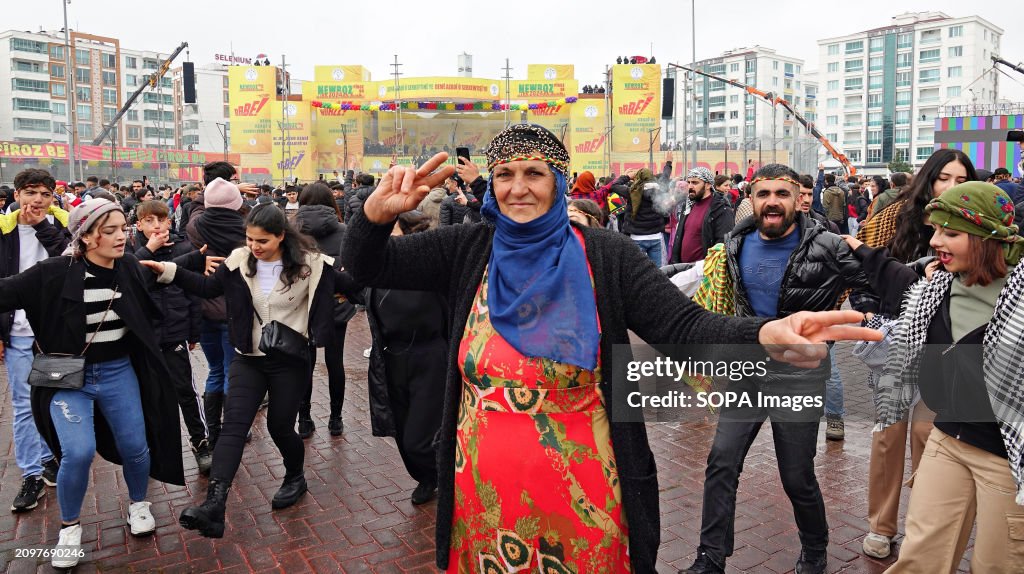 Kurdish people attending the Newroz celebration are seen...