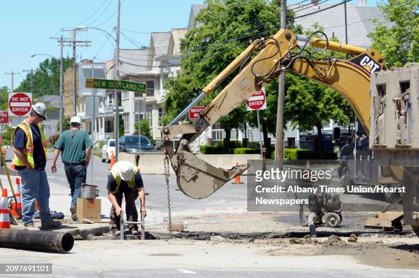 Crews work to repair a hole in the street at the intersection of Myrtle Ave. And New Scotland Ave. On Monday, May 27, 2013 in Albany, NY.