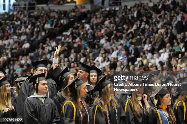 Graduates scan the crowd for family and friends after processing in during the college commencement ceremony for Siena College at the Times Union...