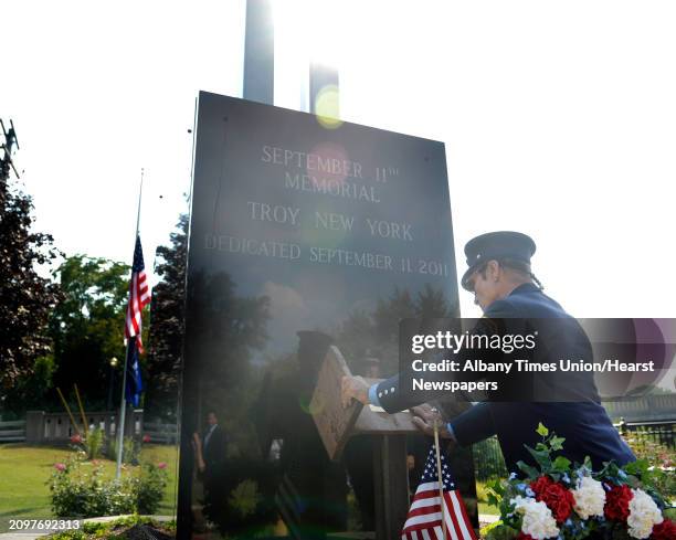 Retired New York City firefighter, Bill Messina, from Latham, reaches down to touch a piece of steel from the World Trade Center site, which is now...