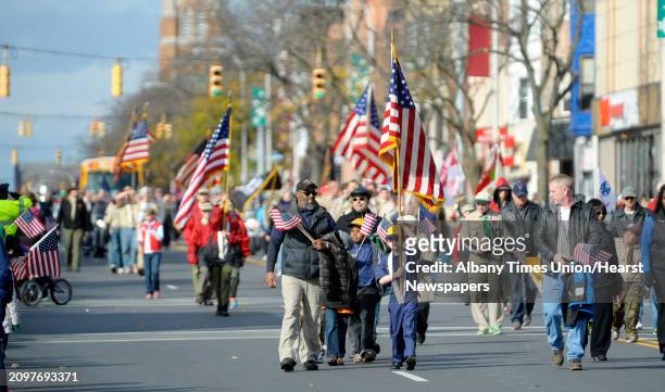 Groups of Cub Scouts march along Central Ave. As they take part in the Veterans Day Parade on Monday, Nov. 11, 2013 in Albany, NY.