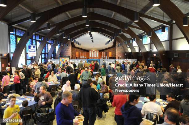 People make their way between the different food tables at the 11th Annual Jewish Food Festival at the Congregation Gates of Heaven on Sunday, March...