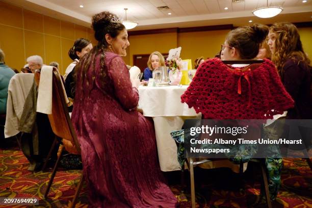 Marie Heller, left, portrays Esther, Queen of Persia, circa 48 B.C. During the annual Famous Ladies' Tea at the Hilton Garden Inn on Sunday, March 16...