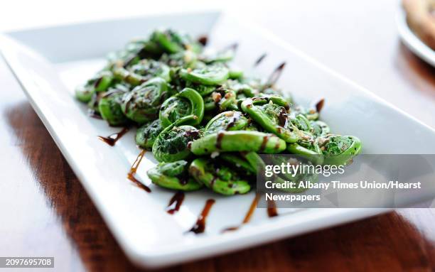 View of a dish of fiddlehead ferns sauteed in olive oil and garlic with a balsamic reduction, photographed at Villago Pizzeria & Ristorante on...