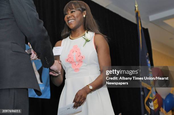 Nicole Daly, owner of Hair Journeys in Albany, walks up to accept her award at the 16th Annual Small Business Excellence Awards luncheon put on by...