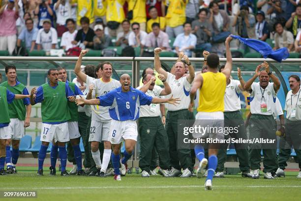 Luiz Felipe Scolari Coach of Brazil watches Roberto Carlos of Brazil run to Rivaldo celebrating after the FIFA World Cup Finals 2002 Quarter Final...