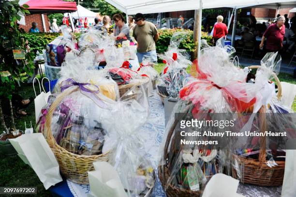 People look over the items that are part of the basket raffle at the Schenectady Polish American Festival at Saint Adalberts Church on Sunday, Aug....