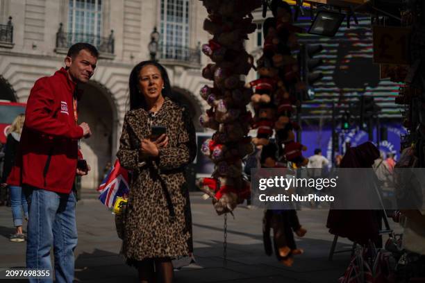 People are walking in Piccadilly Circus, London, on March 21, 2024.