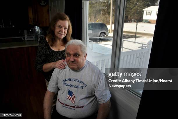 Peter Sajta, foreground, and his wife, Joanne Sajta pose for a photograph inside their home on Thursday, Jan. 8 in Hagaman, N.Y. The VA had a...