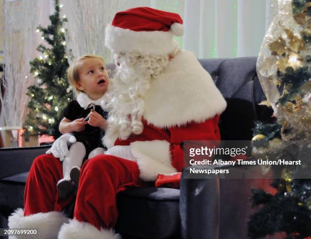 Stella Brodie of Amsterdam visits with Santa during the Brunch with Santa event at Angelo's Tavolo at Glen Sanders Mansion on Sunday, Dec. 21 in...
