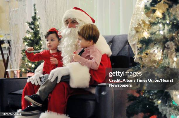 Cousins, Elizabeth Evanchuk, left from Malta and Landon Walters from West Sand Lake, get their photo taken with Santa during the Brunch with Santa...