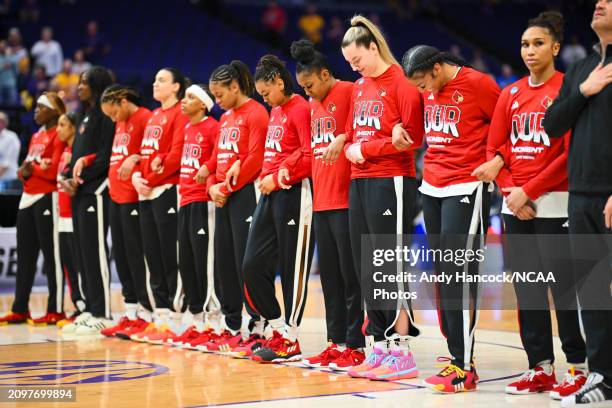 Members of the Louisville Cardinals stand during the national anthem during the first round of the 2024 NCAA Women's Basketball Tournament held at...