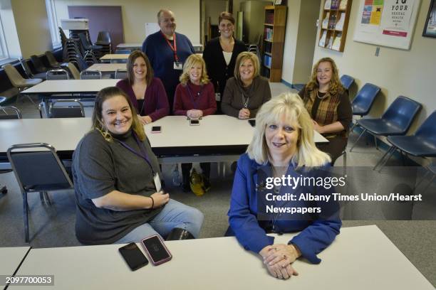 Maryfran Wachunas, foreground right, public health director for Rensselaer County, poses for a photo with helpline volunteers, Desiree Graziano,...