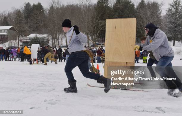 Teams pull their outhouses across the ice on Lake Desolation during the annual Outhouse Races at Tinney's Tavern on Sunday, Jan. 27 in Middle Grove,...