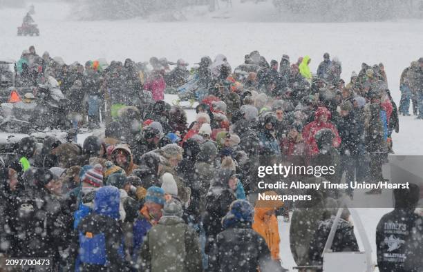 People fill in around the race course on Lake Desolation during the annual Outhouse Races at Tinney's Tavern on Sunday, Jan. 27 in Middle Grove, N.Y.
