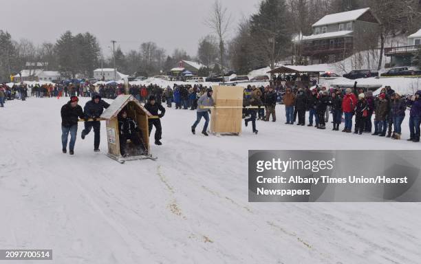 Teams pull their outhouses across the ice on Lake Desolation during the annual Outhouse Races at Tinney's Tavern on Sunday, Jan. 27 in Middle Grove,...