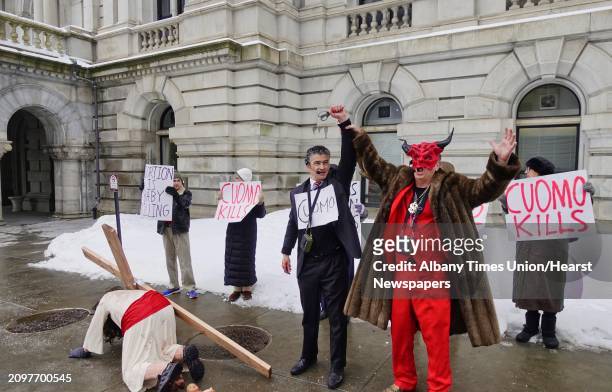 Pro-life leader, Randall Terry, right, dressed as Satan, raises the hand of Gary Boisclair, who plays the part of Governor Andrew Cuomo during a...