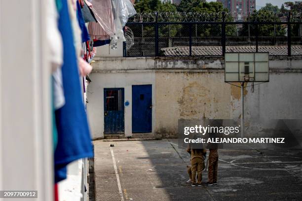 Inmates comb the hair of a fellow prisoner at the courtyard of El Buen Pastor women's prison, in Bogota on February 26, 2024. The Colombian Ministry...