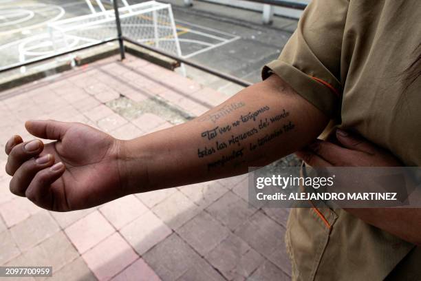 Estefany Villa, convicted for drug trafficking charges, shows her tattoo that reads: "Family, we may not have all the riches in the world but...