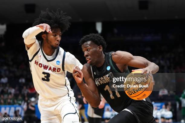 Melvin Council Jr. #11 of the Wagner Seahawks drives the ball against Isiah Warfield of the Howard Bison during the first half in the First Four game...