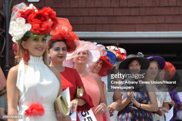 Women competing in the Fashionably Saratoga category, line up for the judges during the 28th Annual Hat Contest Presented by Moet & Chandon And Hat...
