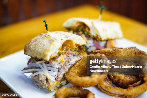 Duck bahn mi, duck confit and duck prosciutto with onion rings at the Albany Pump Station on Thursday, Sept. 19 in Albany, N.Y.