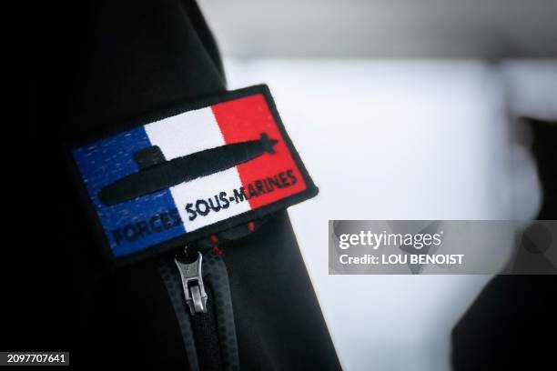 This photograph taken on March 22, 2024 shows a badge of the French submarines forces on a Commander's jacket at the naval base in Cherbourg,...