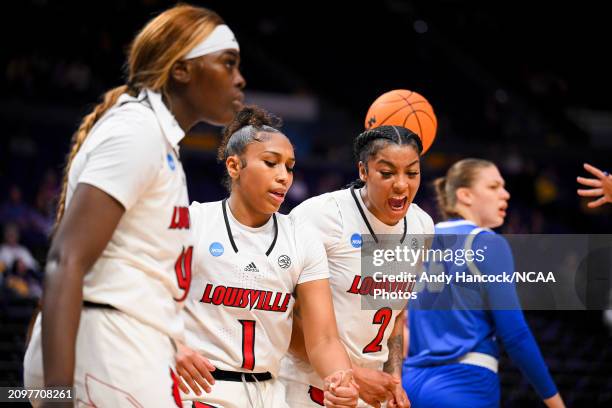 Nyla Harris of the Louisville Cardinals celebrates while Sydney Taylor of the Louisville Cardinals helps a teammate up during the first round of the...