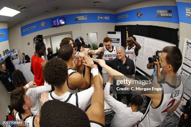 San Diego State Aztecs celebrate in the locker room after their 69-65 win over the UAB Blazers during the first round of the 2024 NCAA Men's...