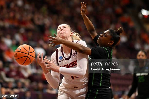 Clara Strack of the Virginia Tech Hokies and Sydni Scott of the Marshall Thundering Herd battle for the ball during the first quarter of the first...