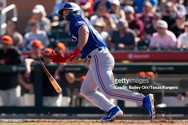 Wyatt Langford of the Texas Rangers hits a single in the third inning during a spring training game against the San Francisco Giants at Scottsdale...