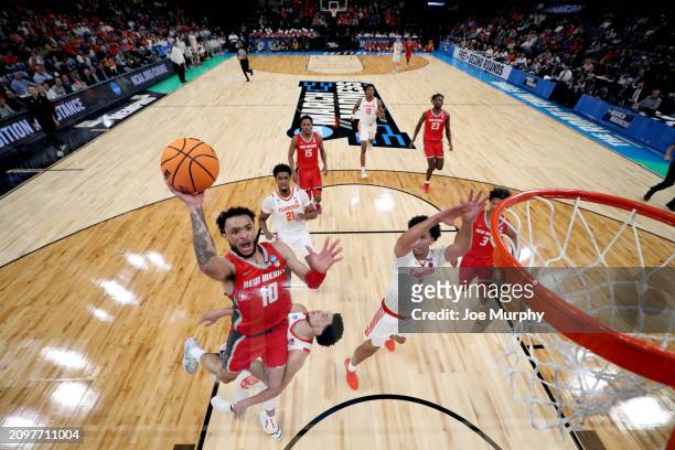 Jaelen House of the New Mexico Lobos takes the ball to the rim against Jack Clark of the Clemson Tigers during the first round of the 2024 NCAA Men's...