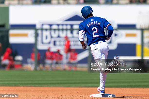 Marcus Semien of the Texas Rangers rounds the bases after hitting a solo home run in the third inning during a spring training game against the Los...