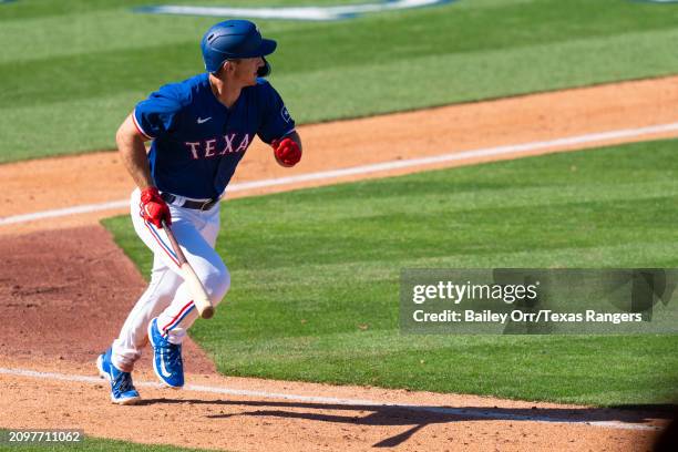 Wyatt Langford of the Texas Rangers hits a three-run home run in the sixth inning during a spring training game against the Chicago White Sox at...