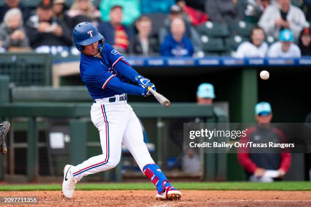 Cam Cauley of the Texas Rangers bats during a spring training game against the Arizona Diamondbacks at Surprise Stadium on March 07, 2024 in...