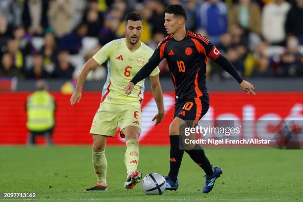 Mikel Merino of Spain and James Rodriguez of Colombia challenge during the international friendly match between Spain and Colombia at London Stadium...