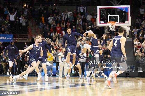 The Yale Bulldogs players celebrate their 78-76 win over Auburn Tigers during the first round of the 2024 NCAA Men's Basketball Tournament held at...