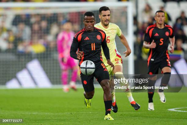 Jhon Arias of Colombia is chased by Mikel Merino of Spain during the international friendly match between Spain and Colombia at London Stadium on...