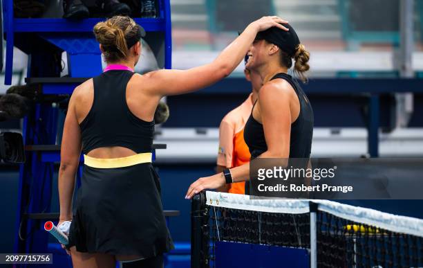 Paula Badosa of Spain and Aryna Sabalenka embrace at the net after the second round on Day 7 of the Miami Open Presented by Itau at Hard Rock Stadium...