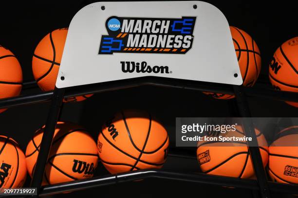 And March Madness logos are displayed on a ball rack holding official Wilson NCAA balls during the Texas Longhorns game versus the Drexel Dragons in...
