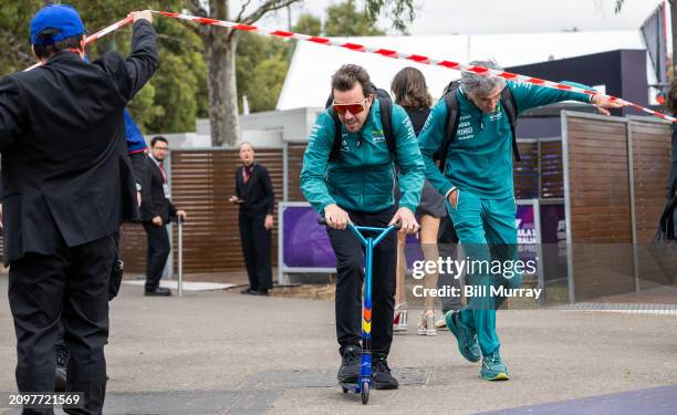 Fernando Alonso of Spain and Aston Martin rides his scooter into the circuit prior to the qualifying ahead of the F1 Grand Prix of Australia at...