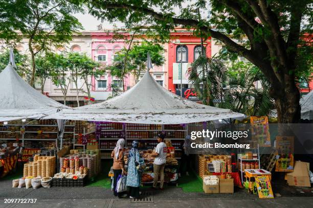 Customers buy food from a street food stall in Kuala Lumpur, Malaysia, on Friday, March 22, 2024. Malaysia is expected to release CPI figures on...