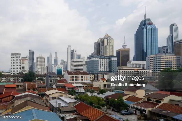 Commercial building beyond houses in Kuala Lumpur, Malaysia, on Friday, March 22. 2024. Malaysia is expected to release CPI figures on March 25....