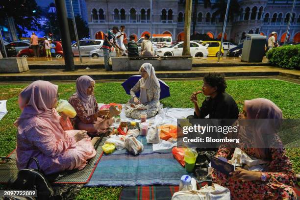 Muslims break their fast during the holy month of Ramadan, near the Independence square, in Kuala Lumpur, Malaysia, on Friday, March 22, 2024....