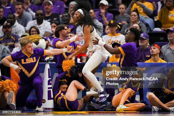 Angel Reese of the LSU Tigers falls into LSU Cheerleaders going to a ball during the first round of the 2024 NCAA Women's Basketball Tournament held...