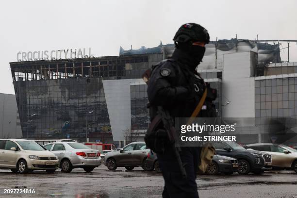 Law enforcement officer patrols the scene of the gun attack at the Crocus City Hall concert hall in Krasnogorsk, outside Moscow, on March 23, 2024....