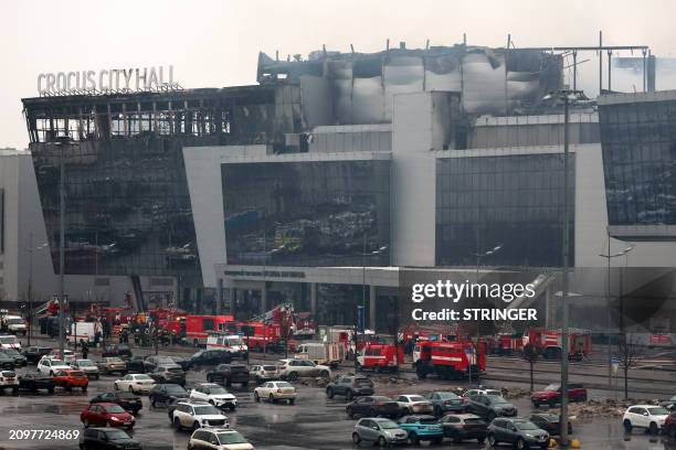 Members of emergency services work at the scene of the gun attack at the Crocus City Hall concert hall in Krasnogorsk, outside Moscow, on March 23,...