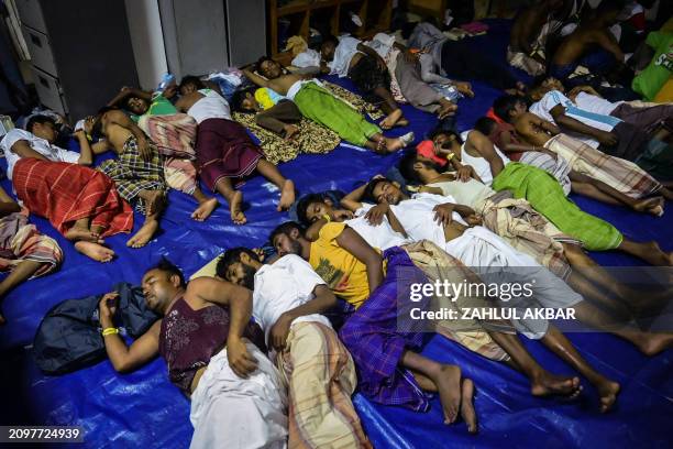 Newly arrived Rohingya refugees sleep at their shelter in Meulaboh, West Aceh, on March 23, 2024.