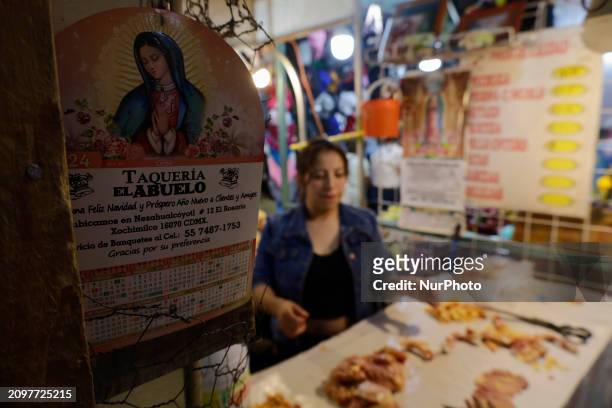 Woman is cutting chicken into pieces for sale at a market in Mexico City. Recently, the Ministry of Health of Tlaxcala in Mexico issued an...